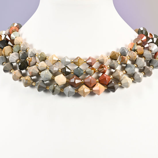 Strand of American Picture Jasper faceted bicone beads, 8mm and 10mm, worn on a jewelry display bust, showing the necklace-length drape.