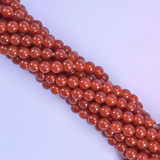 Smooth round cut red agate beads
