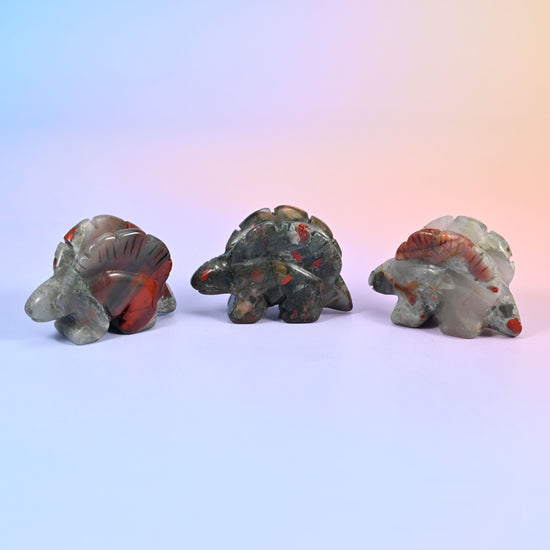 2 inch carved stegosaurus display piece; natural stone, so colour and veining vary from piece to piece