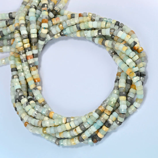 Multi-color amazonite faceted heishi disc beads coiled into overlapping loops, whole strands of mixed blue-green and neutral stone