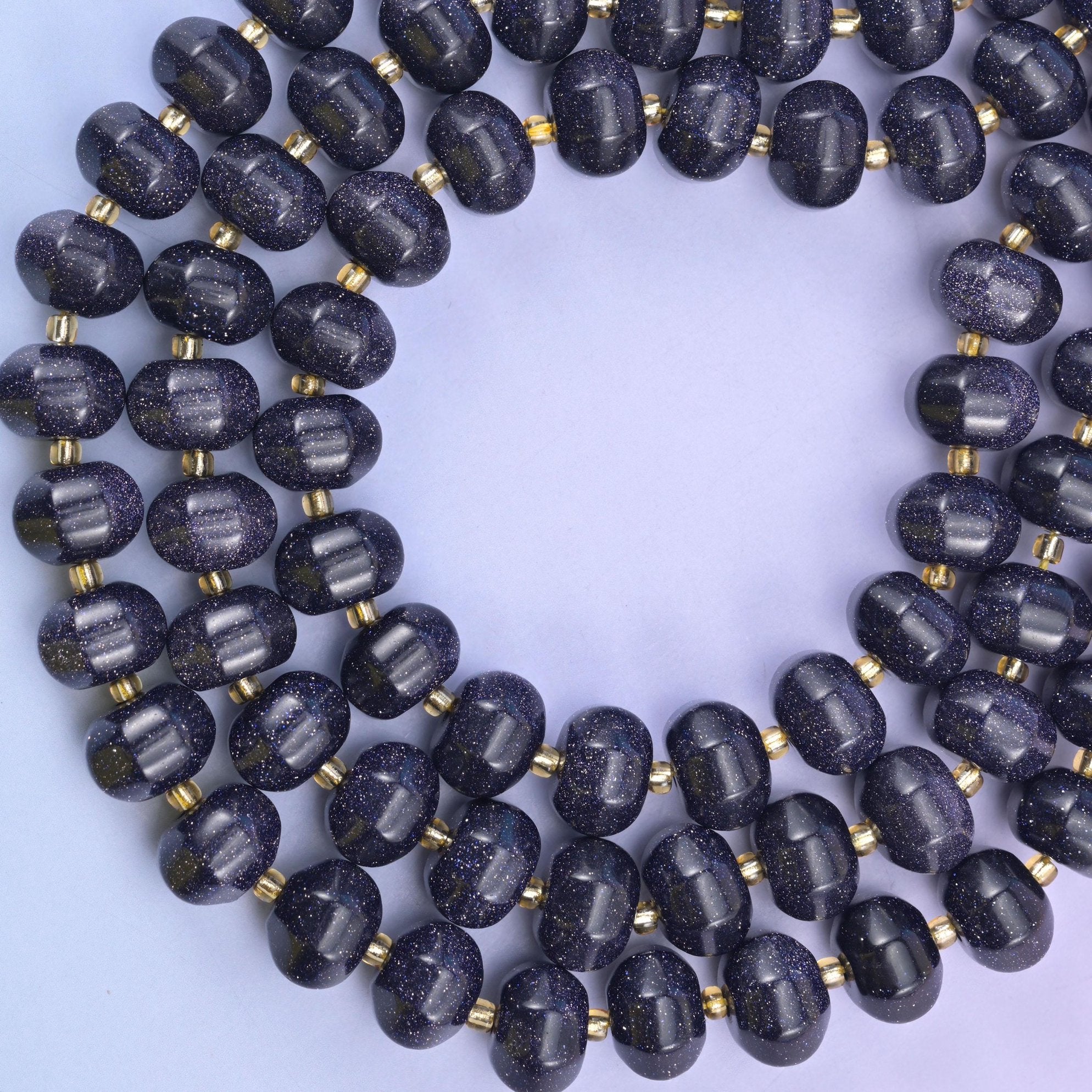 Looped strand of Blue Sandstone pumpkin beads in deep navy