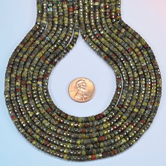 Dragon blood stone faceted heishi disc strands formed into a teardrop loop around a US penny for scale
