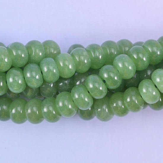 Smooth rondelle cut dyed jade beads with a polished surface