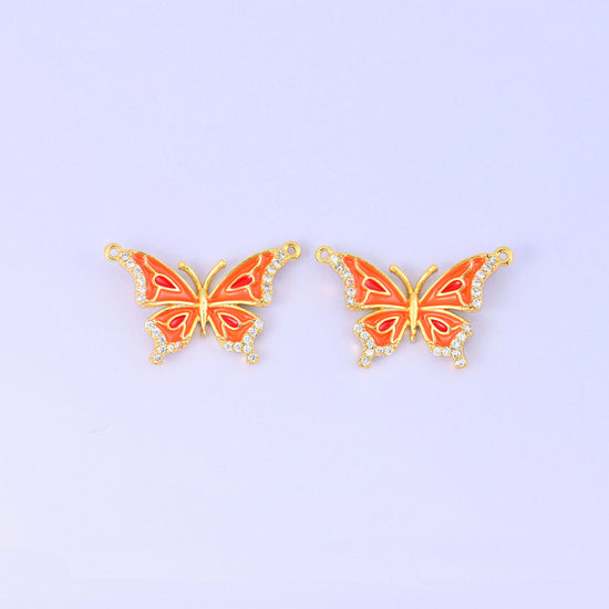 Orange colourway of the enamel butterfly double connector pendant, two gold plated butterflies with orange and red wing markings and zircon set wing edges.