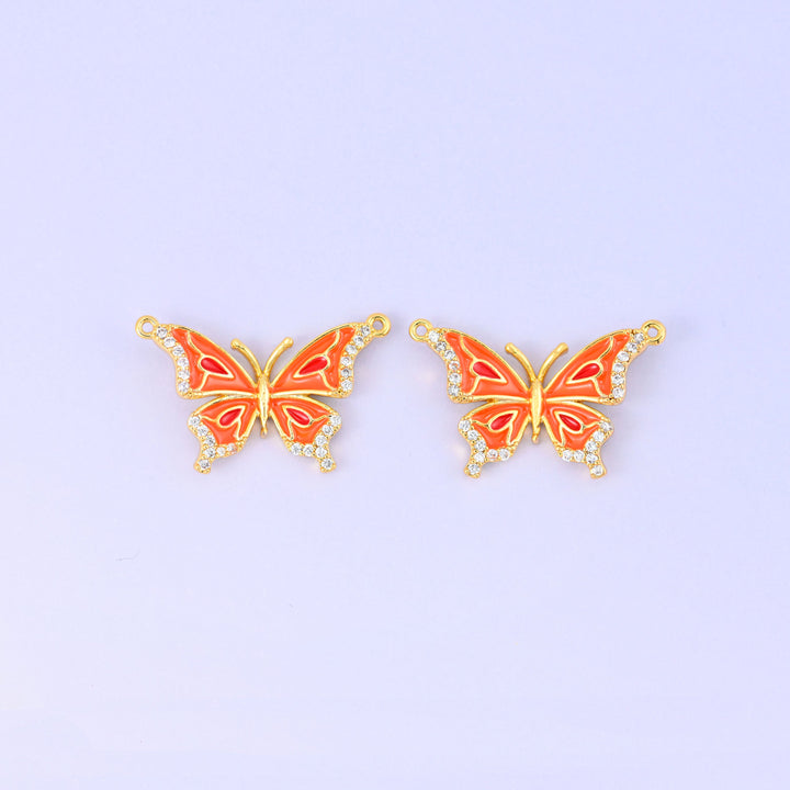 Orange colourway of the enamel butterfly double connector pendant, two gold plated butterflies with orange and red wing markings and zirconia set wing edges.