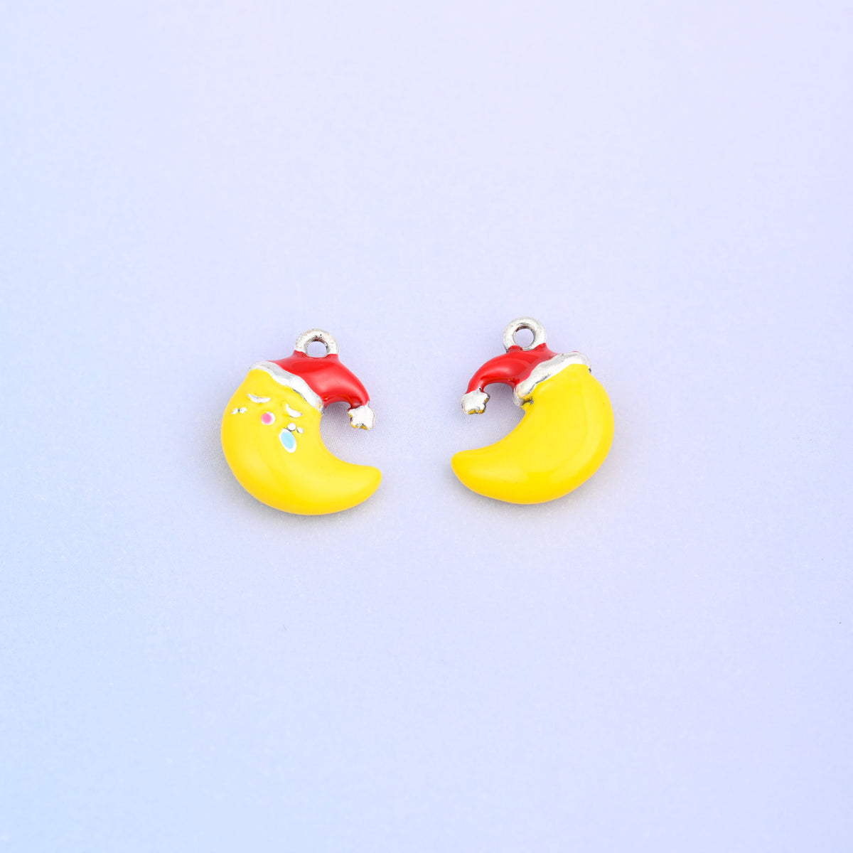 Yellow crescent moon charm in a red Santa hat, shown front and back.