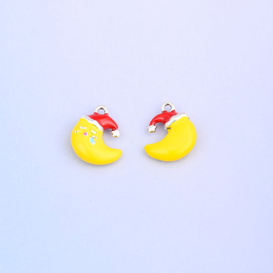 Yellow crescent moon charm in a red Santa hat, shown front and back.