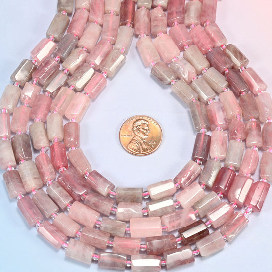 Madagascar multi color rose quartz faceted tube strands curved into a teardrop loop with a US penny at the center.