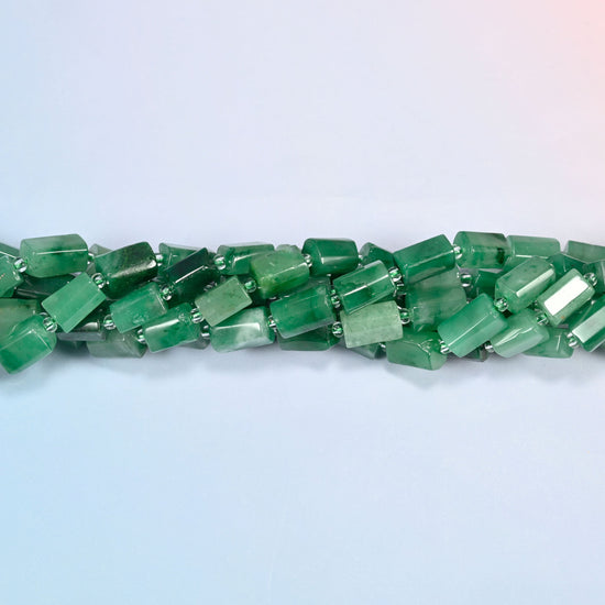 Strands of African jade faceted tube beads twisted together in a horizontal row