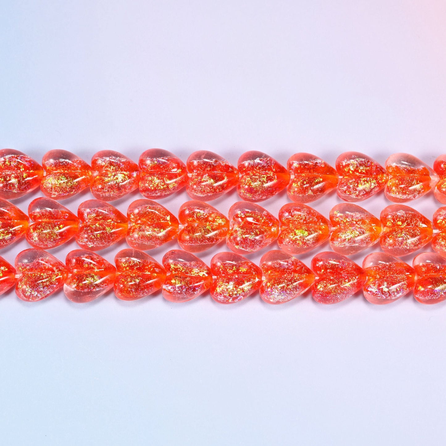 Iridescent Heart Glass Beads in warm coral-red