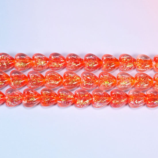 Iridescent Heart Glass Beads in warm coral-red