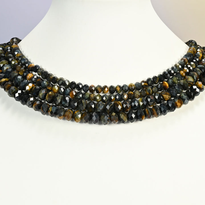 Iron tiger eye beads shown on a white neck display, four faceted rondelle strands layered close to the neckline