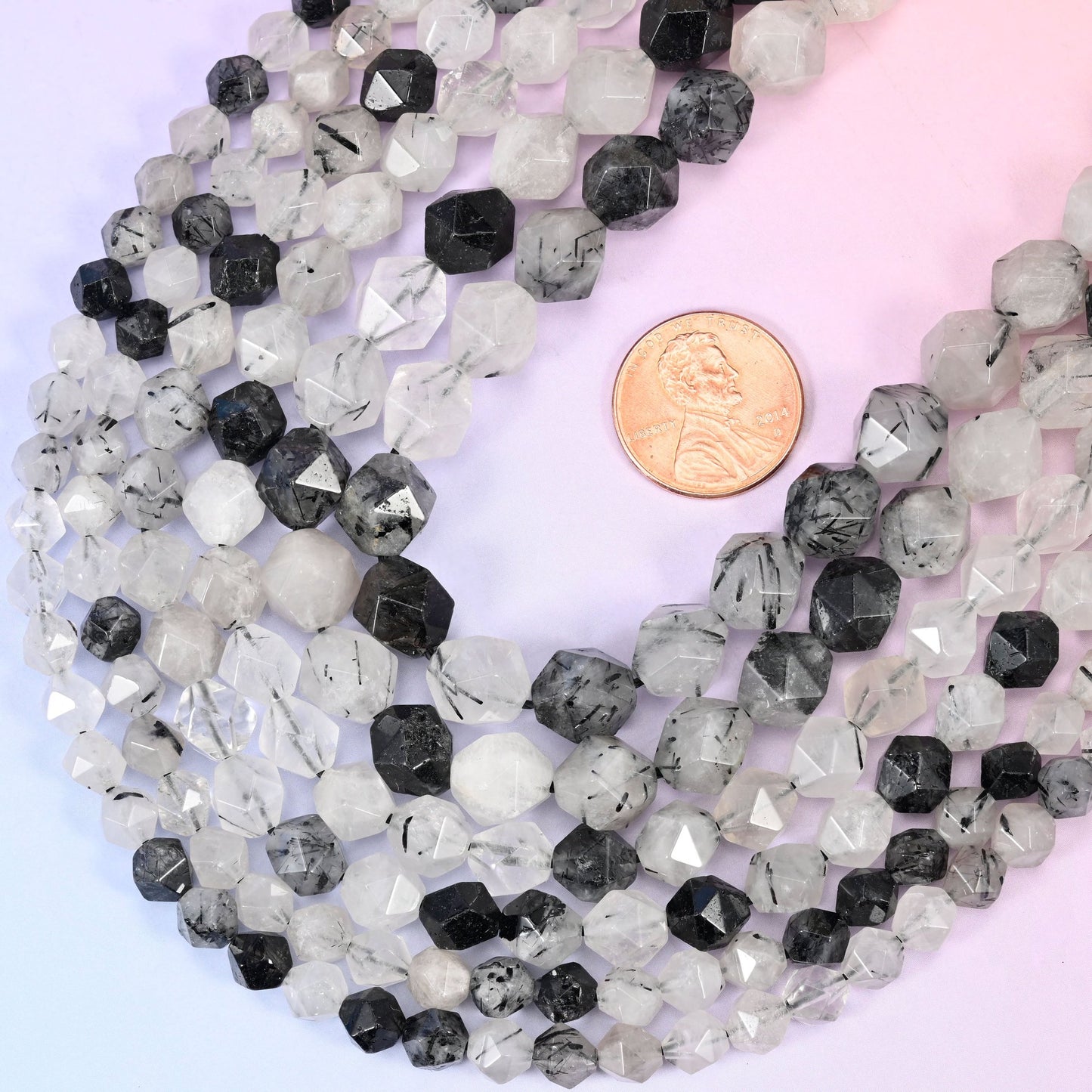 Faceted diamond star cut Black Rutilated Quartz beads.
