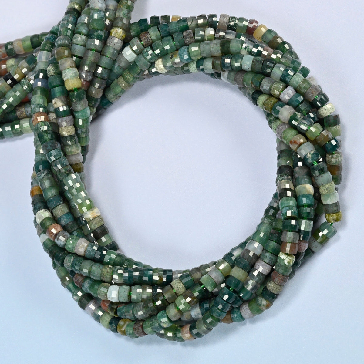 Indian agate faceted heishi disc beads coiled into overlapping loops, whole strands of earthy green stone