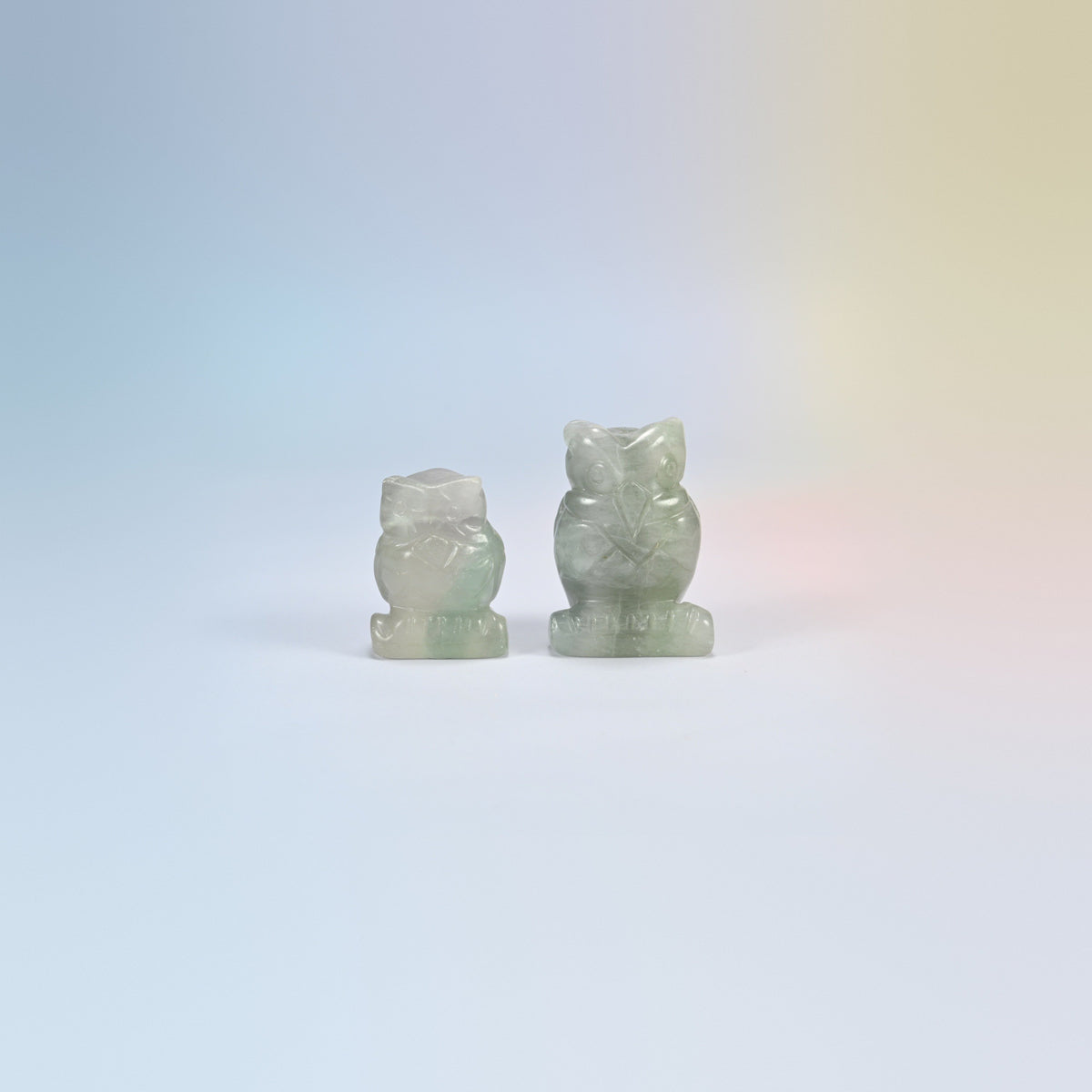 Owl crystal carving in rainbow fluorite, pale green and clear natural stone