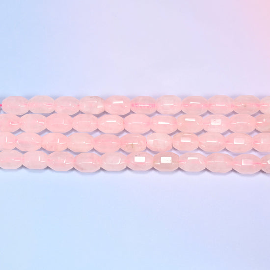 Natural Rose Quartz Faceted Barrel Beads in soft translucent blush pink.