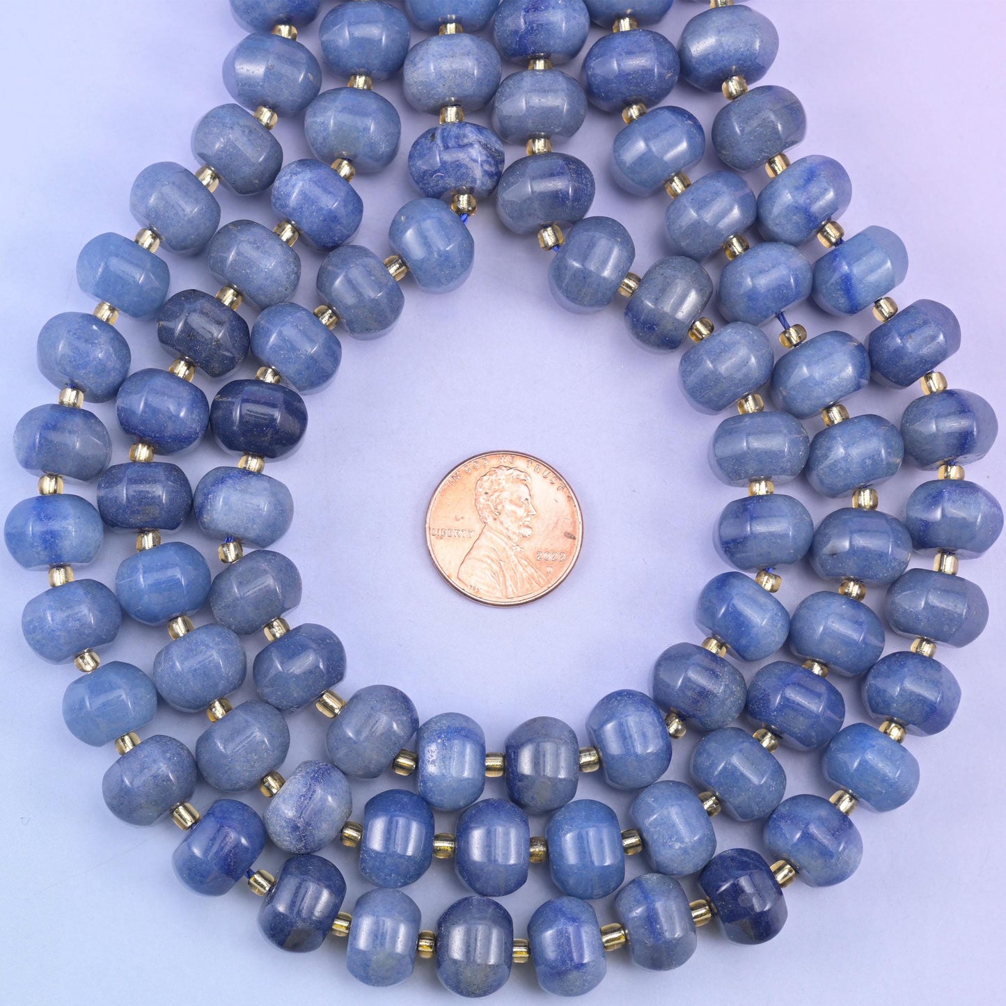 Penny centred inside a ring of coiled strands, giving a familiar reference for bead diameter