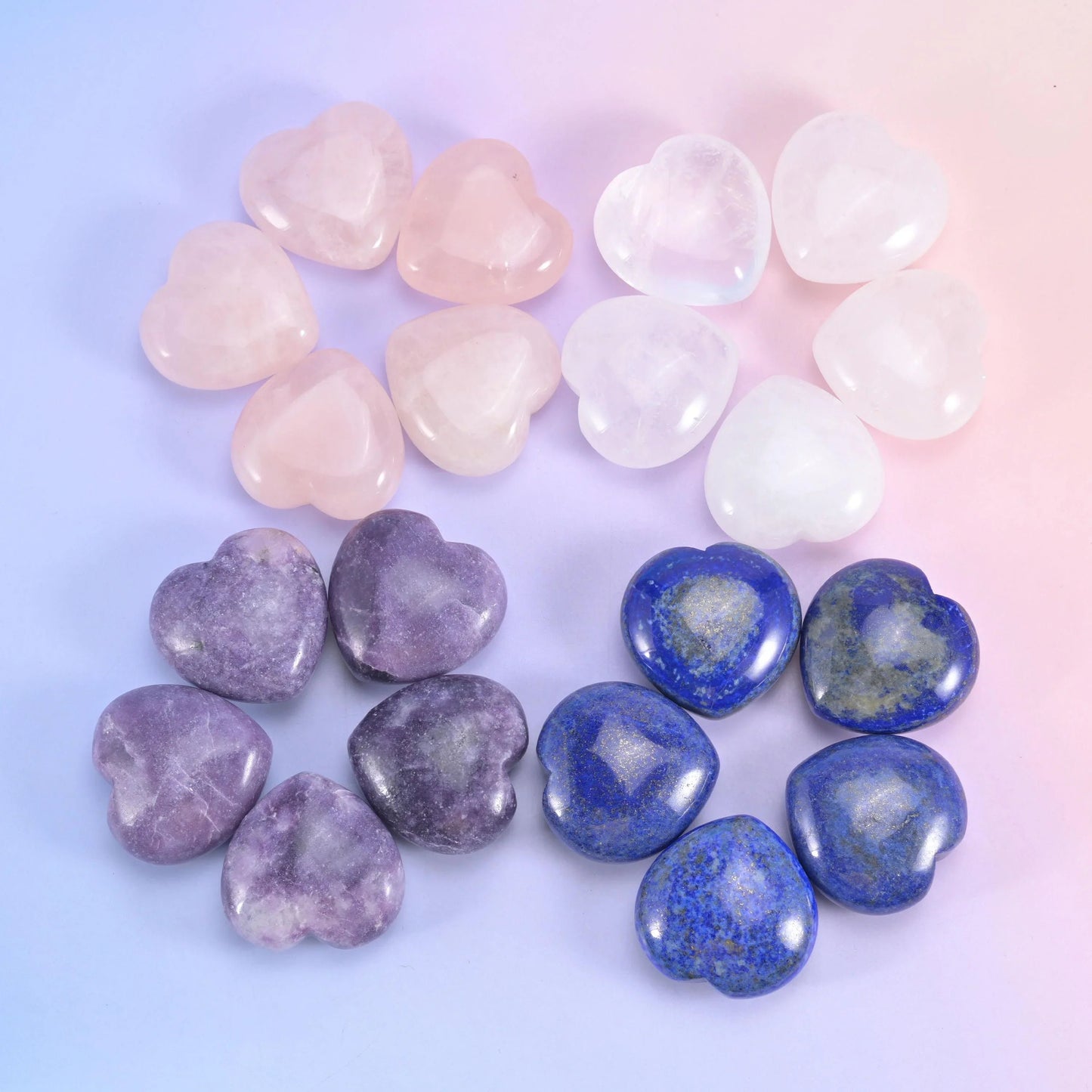 Soft pastel hearts laid out in fours, rose quartz, clear quartz, lilac lepidolite and deep blue lapis
