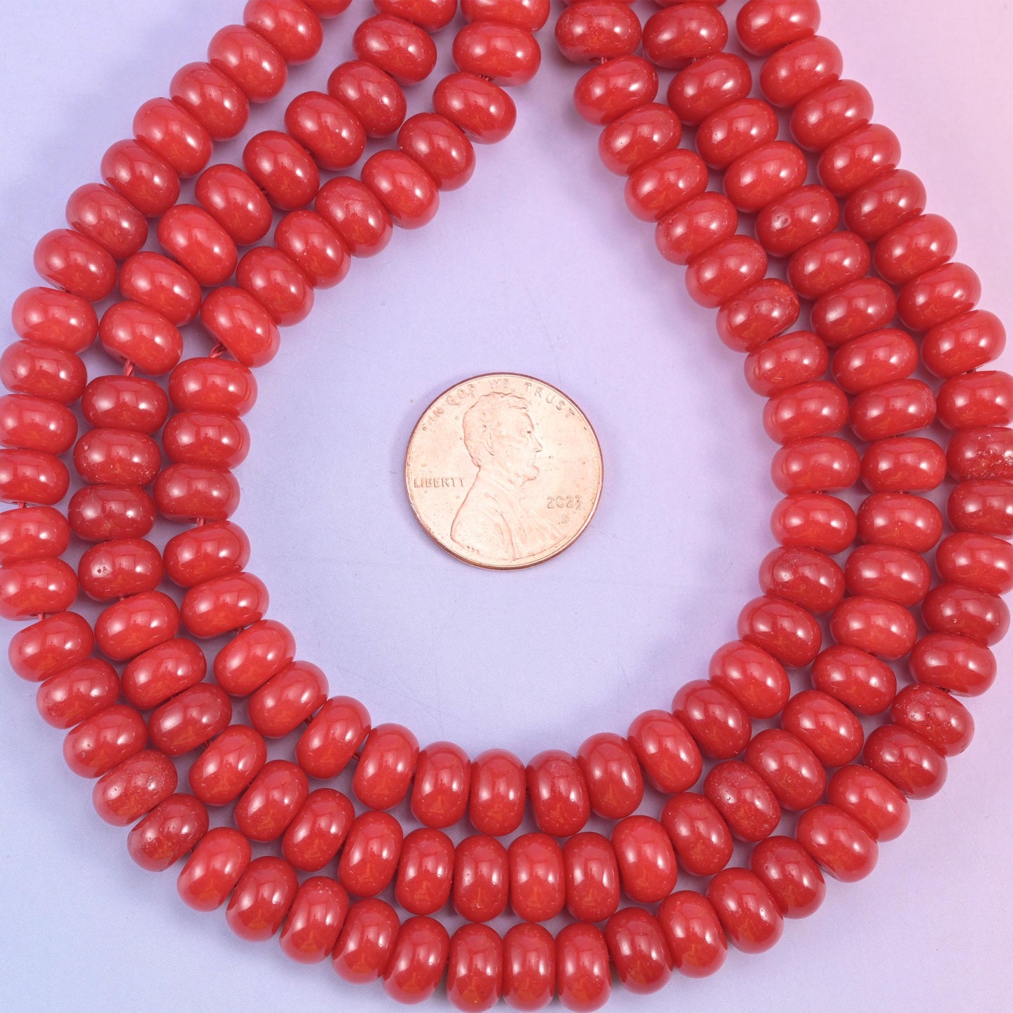 Red Dyed Jade smooth rondelle beads in a bold, glossy cherry red, finished with a smooth, polished surface