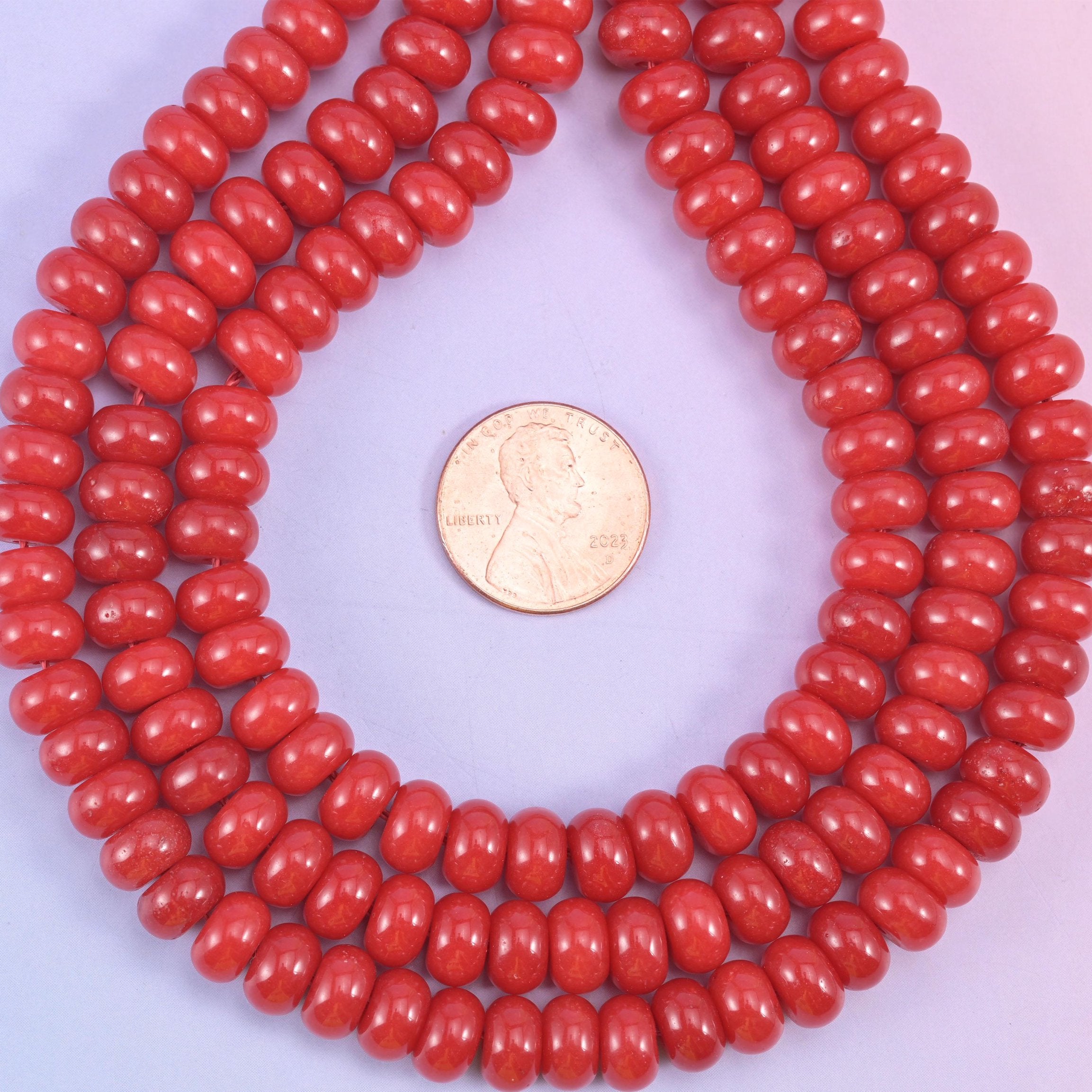 Red Dyed Jade smooth rondelle beads in a bold, glossy cherry red, finished with a smooth, polished surface