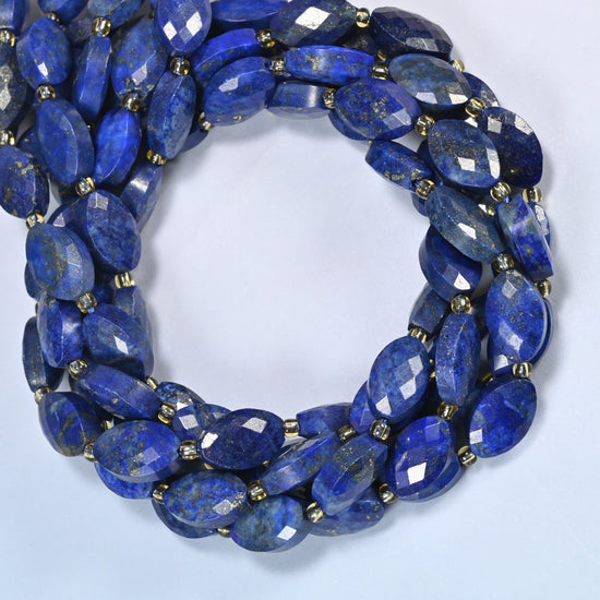 Lapis lazuli faceted flat oval beads coiled into overlapping loops, whole strands of deep blue stone