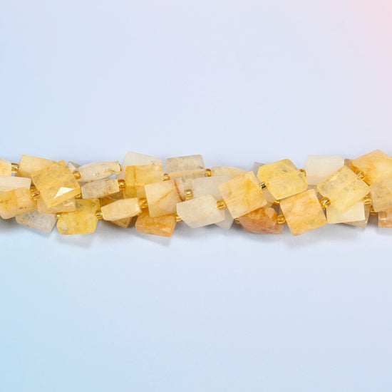 Strands of natural golden healer quartz faceted flat square beads twisted together in a horizontal row