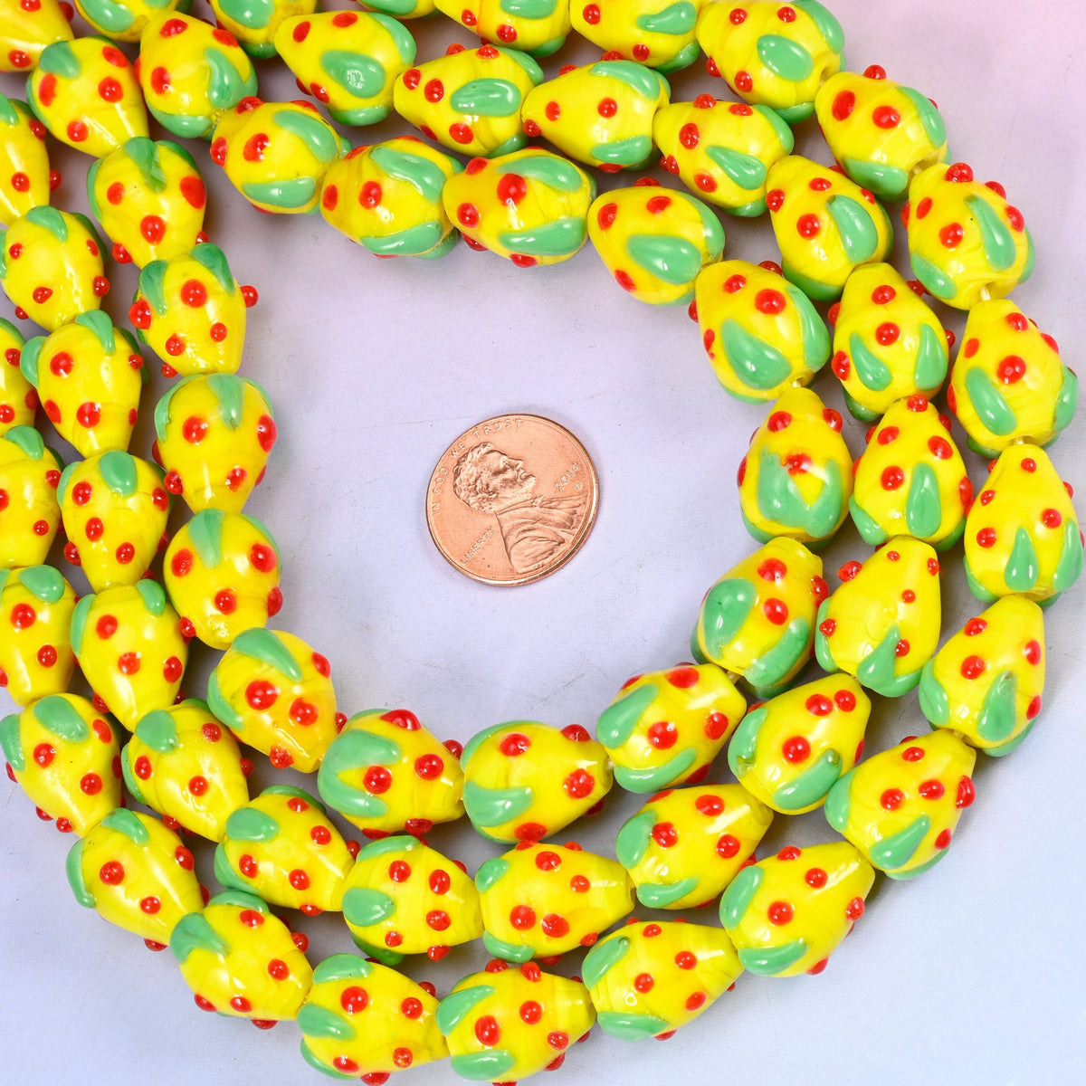 Glossy yellow glass strawberries for jewelry making