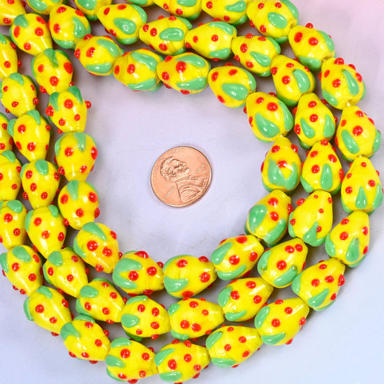 Glossy yellow glass strawberries for jewelry making