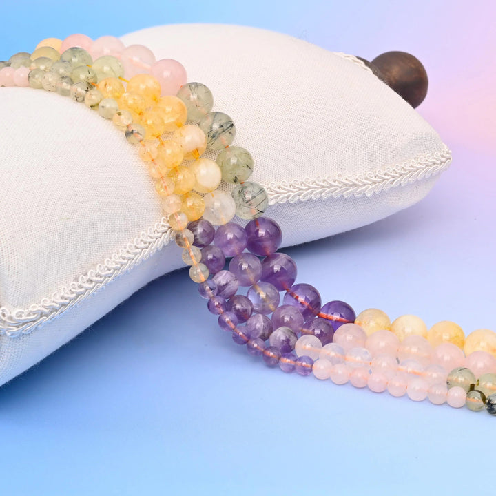 Prehnite, Rose Quartz, Amethyst and Citrine Smooth Round Beads in a soft four-stone pastel palette.