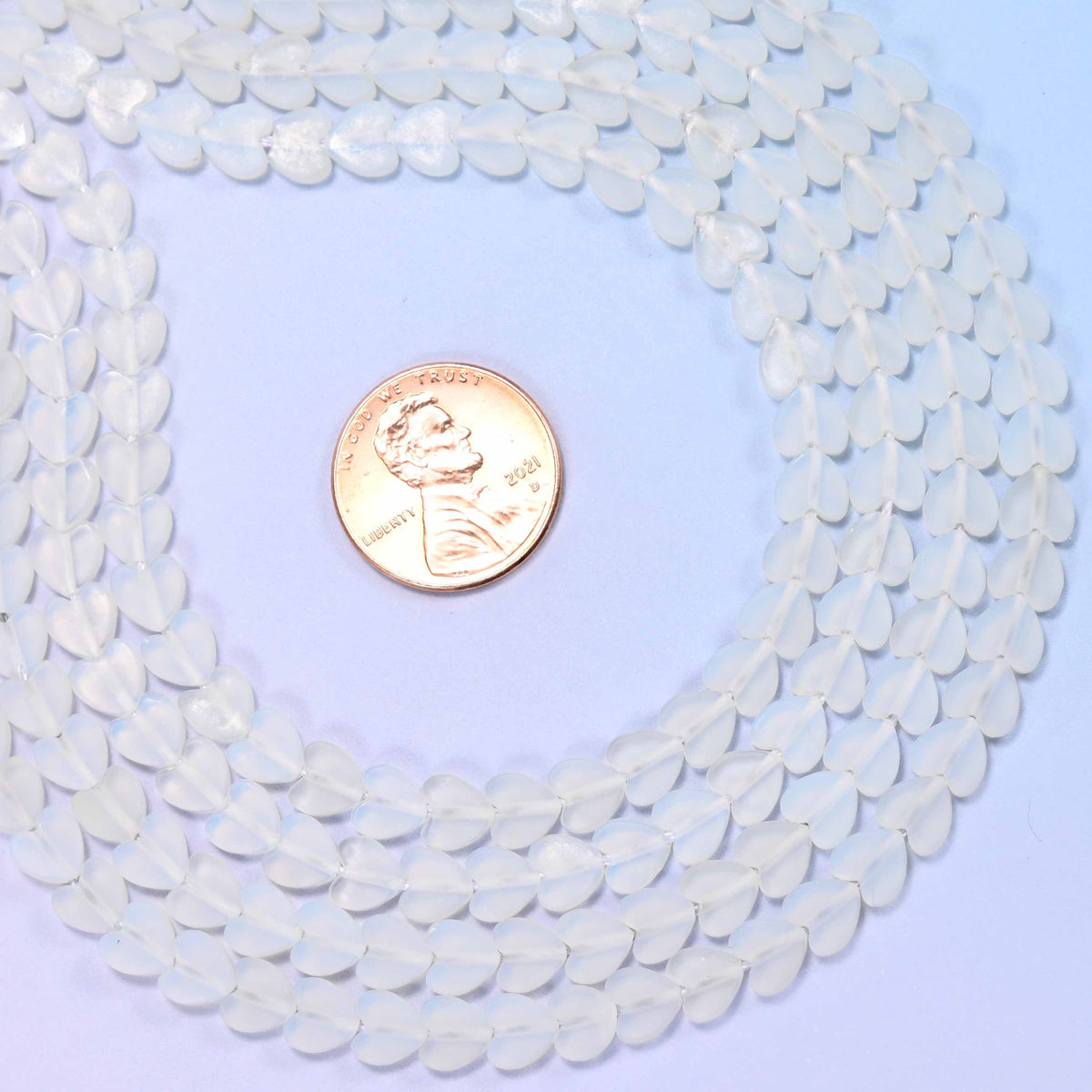 Matte Opalite Flat Heart Beads, milky translucent hearts with a faint cool blue-white glow