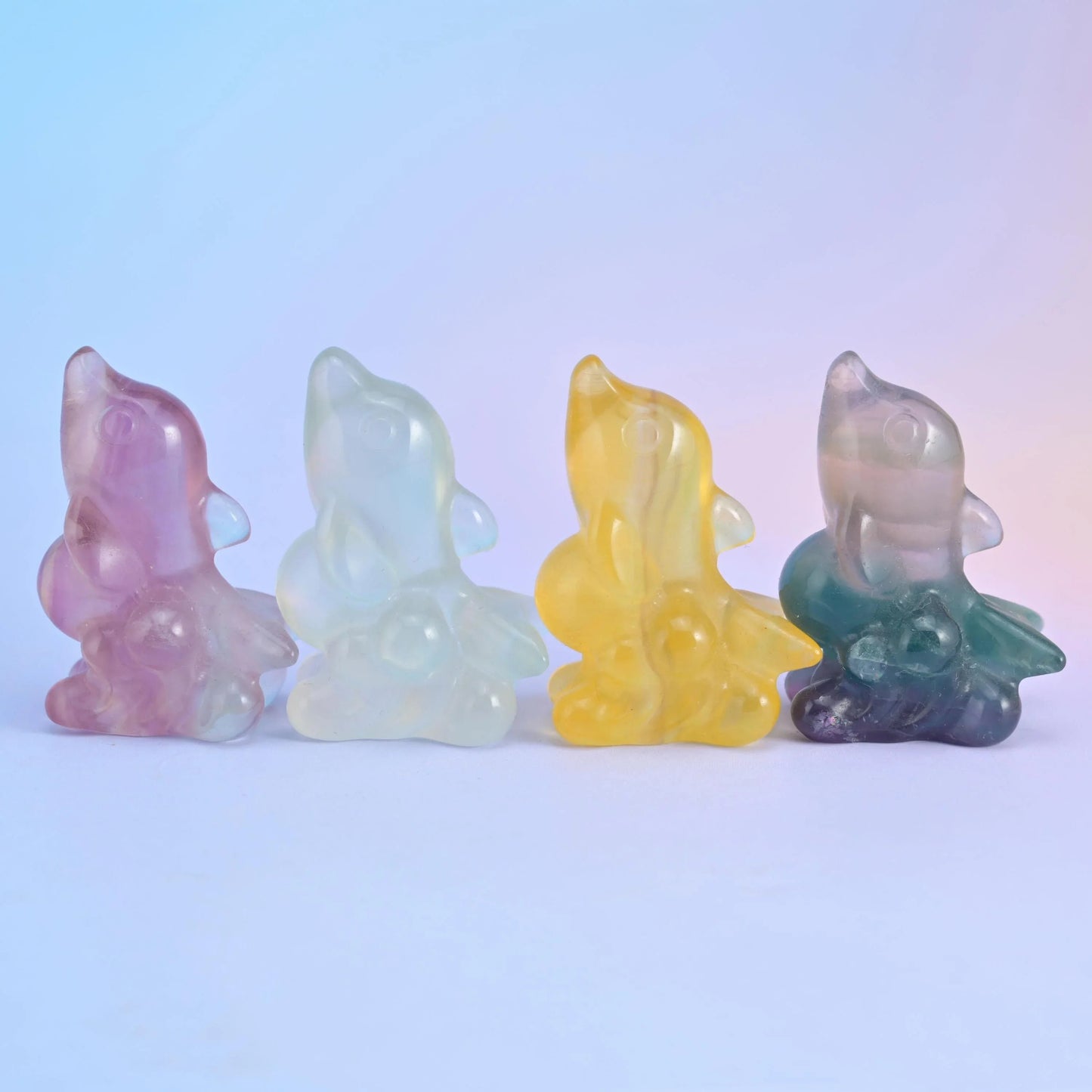 A small dolphin rising from a curling wave base, carved from banded fluorite