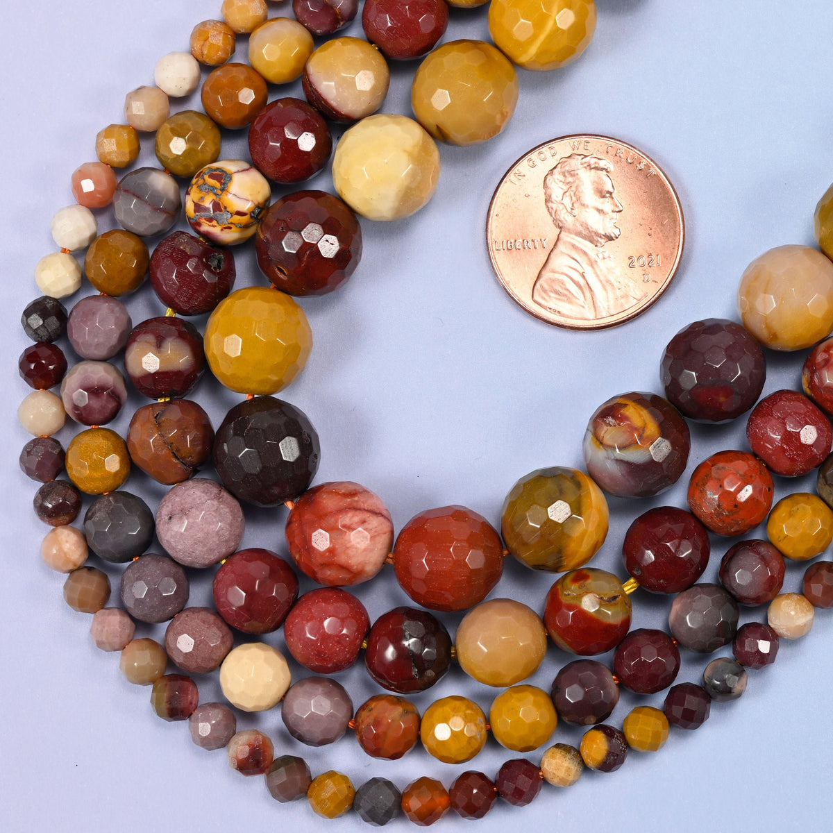 Faceted round cut mookaite beads
