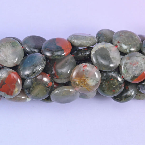 Macro side view of Bloodstone coins showing thickness and glassy polish