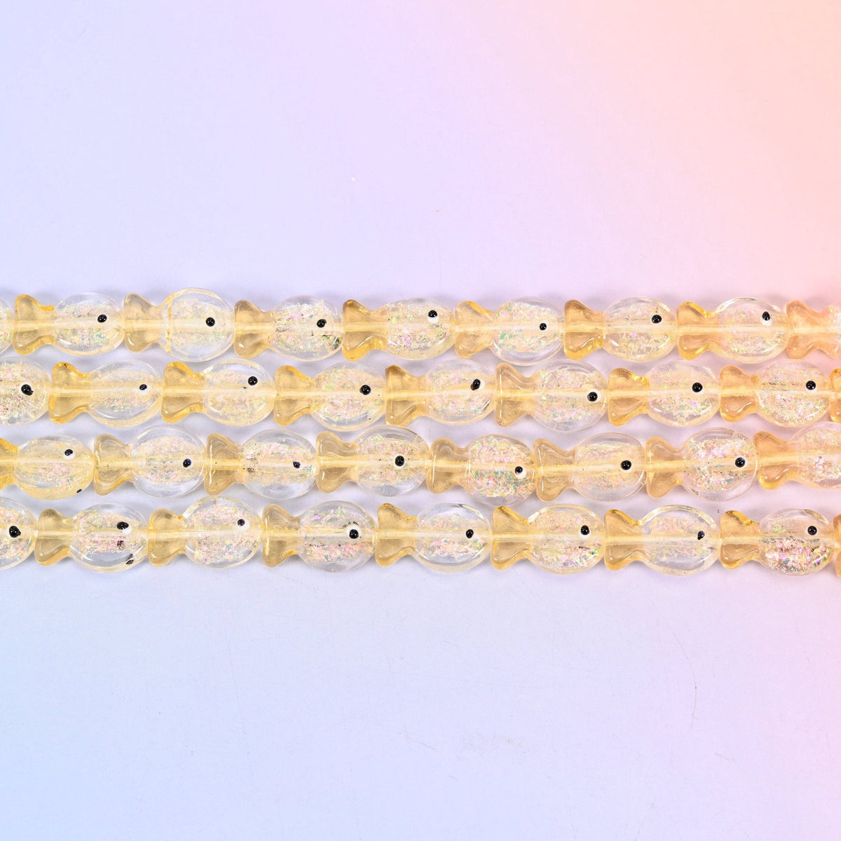 Iridescent Yellow Fish Glass Beads in butter-yellow glass with gold glitter