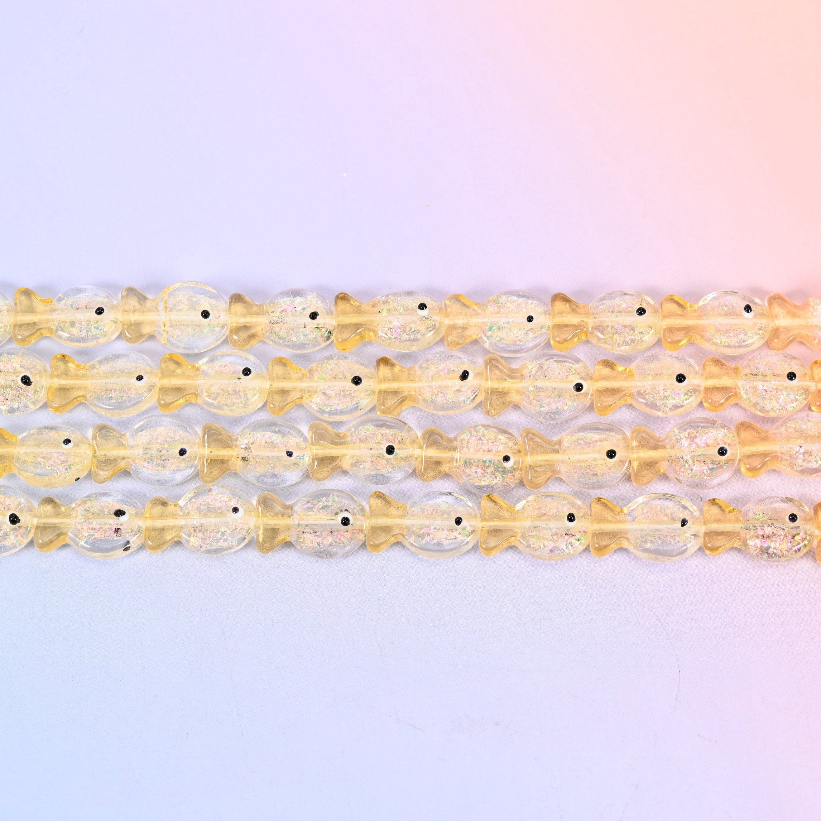 Iridescent Yellow Fish Glass Beads in butter-yellow glass with gold glitter