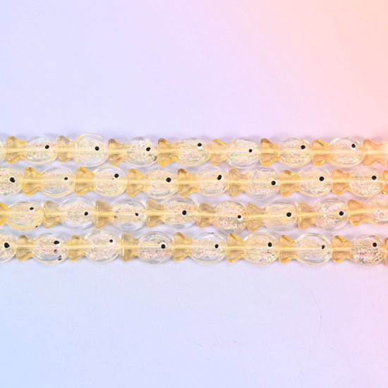 Iridescent Yellow Fish Glass Beads in butter-yellow glass with gold glitter