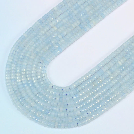 Aquamarine chalcedony faceted heishi disc beads in several strands curved into a wide U, light icy blue translucent stone