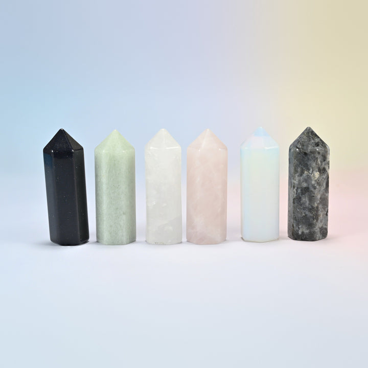 Six hexagon crystal points in a row: blue sandstone, opalite, and natural green aventurine, clear quartz, rose quartz and black labradorite
