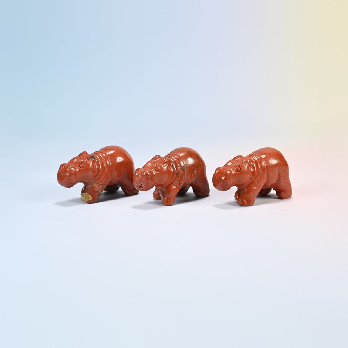Three natural red jasper hippo crystal carvings, 2 inch, brick red