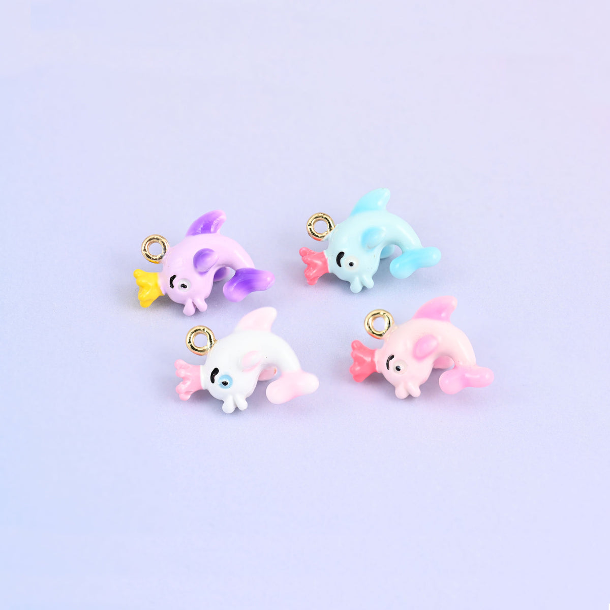 Dolphin charms with crowns in all four colors, light blue, white, pink and light purple enamel.