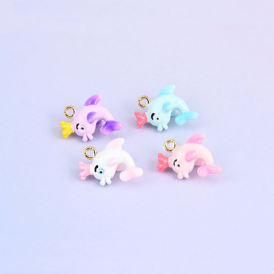 Dolphin charms with crowns in all four colors, light blue, white, pink and light purple enamel.