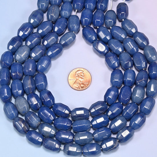 Wide circular coil of blue faceted Aventurine barrel bead strands forming a full wreath shape on a light blue background.