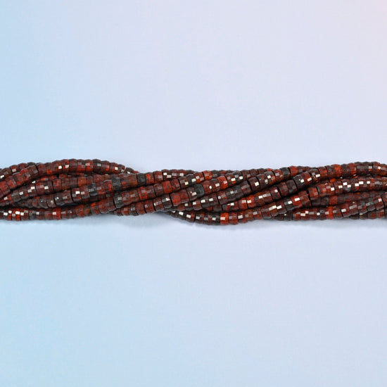 Strands of Zhanguo red agate faceted heishi disc beads twisted together in a horizontal row