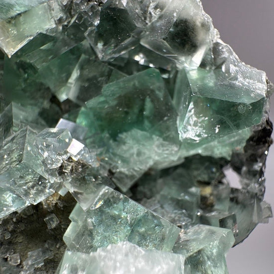 Macro detail of interlocking green Fluorite cubes and their glassy faces