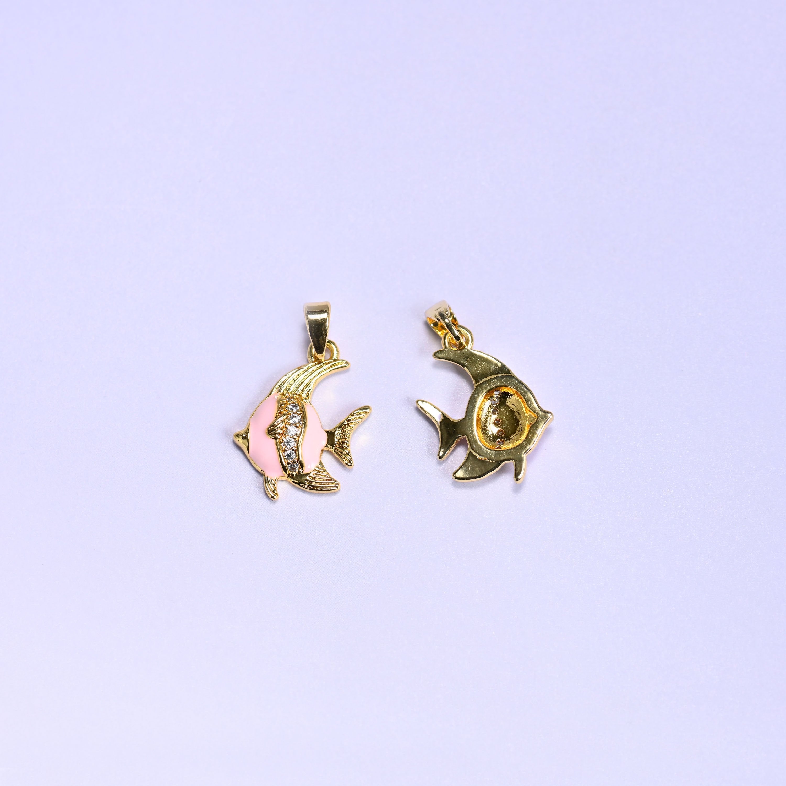Tropical fish charm with an enamel body and gold fin and tail details