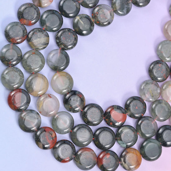 Bloodstone coin strands sweeping in a curve, red patches against grey-green