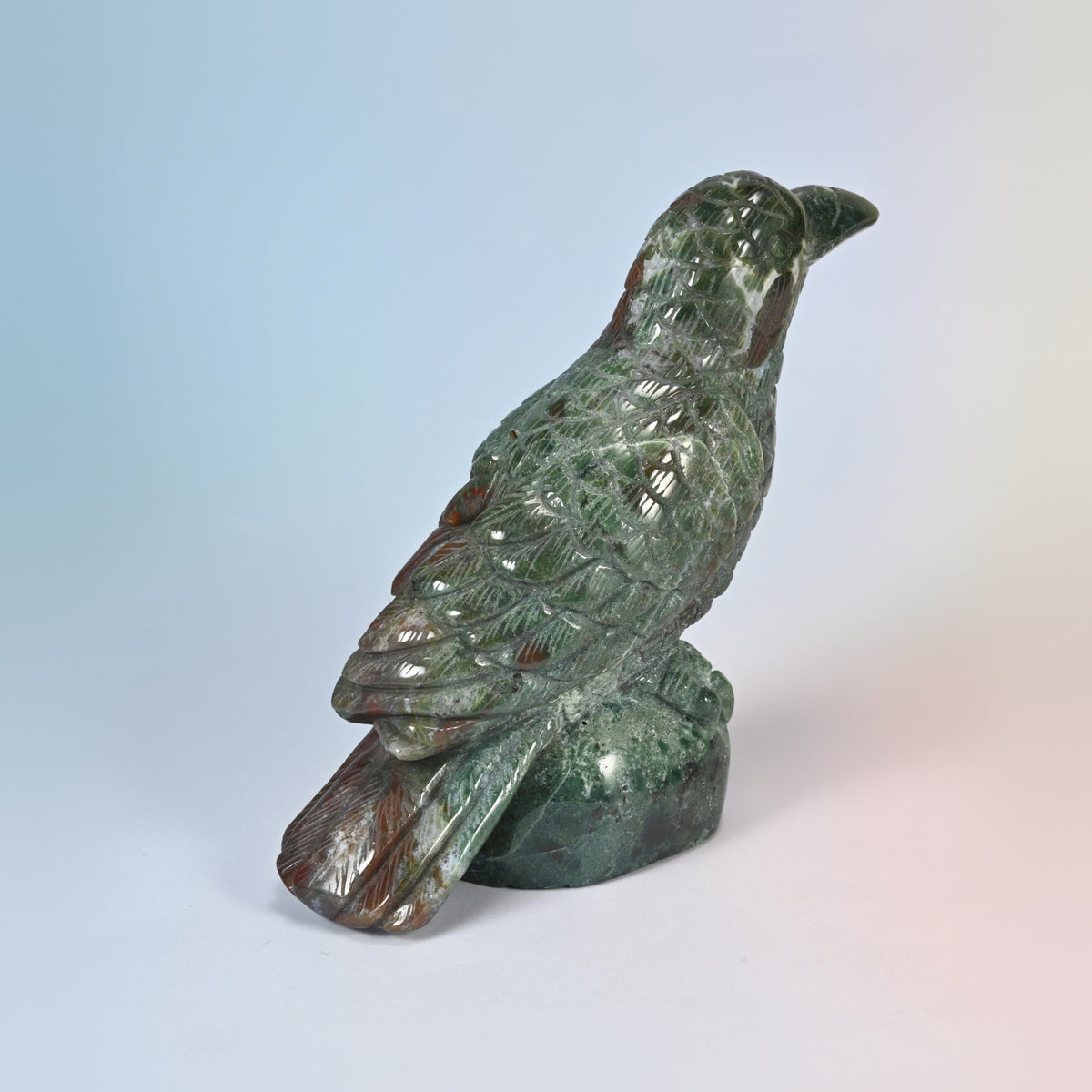 Rear three-quarter view of the Indian agate crow, carved wings and red tail