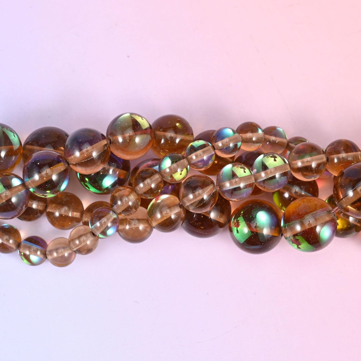 Clear smoky brown glass with a peacock-green and gold iridescent panel set into one side, fully polished