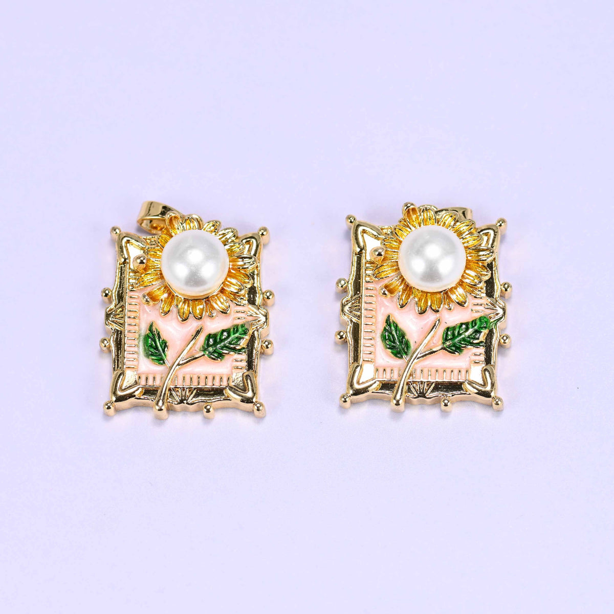Sunflower charm with a faux pearl center and textured gold petals