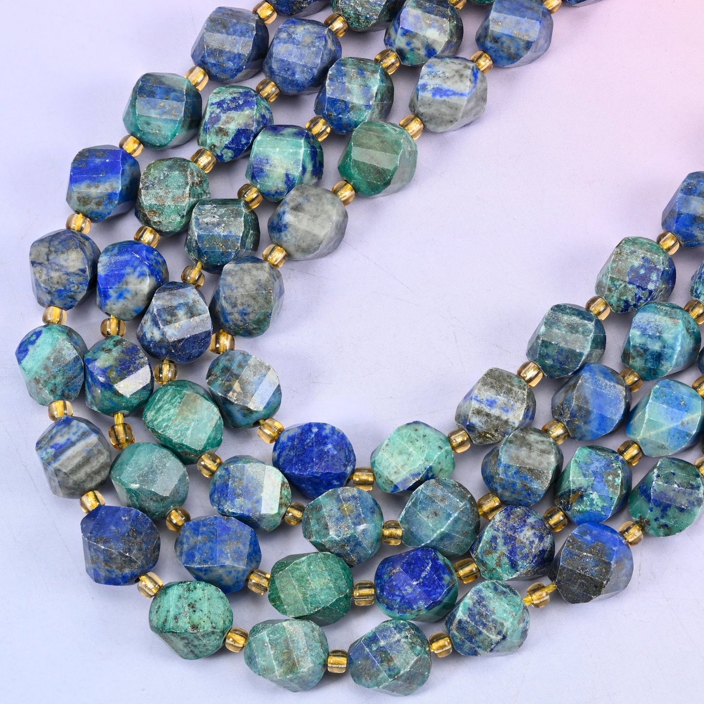 Phoenix Lapis lapis lazuli beads, many-sided spiral twist cut catching light on every facet, 10mm